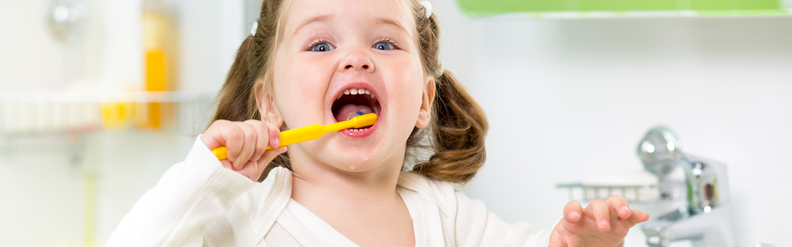 A little girl brushing her teeth